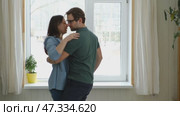 Emotional Dance. Middle-aged Couple Dancing Together Embrace at Home. Mature Couple dancing bonding, smiling and moving to the rhythm in a romantic vibe enjoying their anniversary. Active relationship. Стоковое видео, видеограф Марина Демидюк / Фотобанк Лори