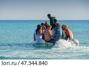 Hurghada, Egypt- Mar 12 2023, a close up view of group of people, tourists, swim on rubber boat on Red Sea, at daytime, Hurghada, Egypt. Редакционное фото, фотограф Сергей Богомяко / Фотобанк Лори