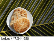 Amazing Sri Lankan three pol coconut roti in white plate. Authentic recipe. Стоковое фото, фотограф Светлана Лажко / Фотобанк Лори