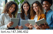 A friendly gathering of four individuals holding tablets and smiling warmly, set against a stylish indoor backdrop filled with natural light and greenery. Стоковое AI-изображение, AI-художник Sergey Grishin / Фотобанк Лори
