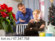 Father is unhappy with his son and expresses his displeasure during holiday of christmas. Стоковое фото, фотограф Яков Филимонов / Фотобанк Лори