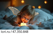 Young child with whimsical angel wings looks curiously at small glowing candle while lying on soft blanket. Warm lights create magical atmosphere in room. Tooth fairy and fallen (milk) teeth concept. Стоковое AI-изображение, AI-художник Sergey Grishin / Фотобанк Лори