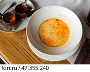 Small portion of traditional Bulgarian first course, shkembe chorba, is served in deep plate. Стоковое фото, фотограф Яков Филимонов / Фотобанк Лори