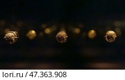 Abu Dhabi, United Arab Emirates - Jan 17 2024, Close-up view of the ancient antique coins in the Louvre Abu Dhabi Museum, belonging to different eras, Abu Dhabi, United Arab Emirates. Редакционное фото, фотограф Сергей Богомяко / Фотобанк Лори