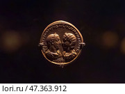 Abu Dhabi, United Arab Emirates - Jan 17 2024, Close-up view of the ancient antique coins in the Louvre Abu Dhabi Museum, belonging to different eras, Abu Dhabi, United Arab Emirates. Редакционное фото, фотограф Сергей Богомяко / Фотобанк Лори