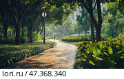 A sunny morning park with a paved path, smoothly curving among the greenery. Tall slender trees create a light shadow, and soft light streams through the foliage. Neat bushes and lush tropical plants with wide leaves grow along the path. A cozy and well-kept space, as if specially created for leisurely walks, morning jogging or relaxation. The atmosphere is calm, fresh and peaceful, you can feel the closeness to nature and the comfort of the urban environment. Стоковое AI-изображение, AI-художник Анна Кривицкая / Фотобанк Лори