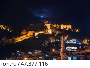 Alanya, Antalya, Türkiye, Turkey, Panoramic view of the Alanya fortress and the mountains covered with forest, cityscape, with illumination, in the dark sky a blue crescent moon, at nighttime (2023 год). Стоковое фото, фотограф Сергей Богомяко / Фотобанк Лори