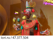 Doha, Qatar - Jan 06 2024, A close-up view of ancient ceremonial masks and clothes, masks depict various scary faces, history of coffee,on exhibition of National Museum of Qatar, Doha, Qatar. Редакционное фото, фотограф Сергей Богомяко / Фотобанк Лори