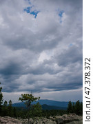 Bad weather in the mountains. gloomy dark clouds with blue gaps of clear sky. sky light. Стоковое фото, фотограф Екатерина Якименко / Фотобанк Лори