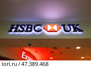 Illuminated HSBC UK Bank Sign at Indoor Branch. London, UK, 24 December 2023. Редакционное фото, фотограф Zydrius Tartenis / Фотобанк Лори