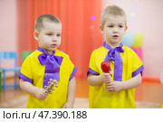 Belarus, the city of Gomel on March 2, 2018. Kindergarten for children. Children's holiday.Little children with musical instrument bells. Редакционное фото, фотограф Лазаренко Светлана / Фотобанк Лори