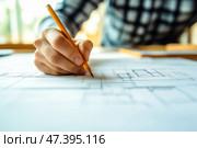 An engineer draws a drawing of an architectural and technical project on a table. The architect's work is on the studio table. Стоковое AI-изображение, AI-художник Ирина Ручушкина / Фотобанк Лори