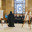 Manama, Bahrain - Jan 15 2024, An Arab woman dressed in a black burqa and niqab enthusiastically tells group of tourists about history of Islam inside of the Grand Mosque Al Fateh, Manama, Bahrain. Редакционное фото, фотограф Сергей Богомяко / Фотобанк Лори