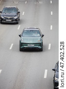 High angle photo of a green EV car Zeekr X driving on a highway. Редакционное фото, фотограф Константин Григорьев / Фотобанк Лори