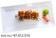 Plate is filled with crunch California rolls with fried puffed rice. Стоковое фото, фотограф Яков Филимонов / Фотобанк Лори