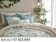 Stylish bedroom with floral bedding and natural decor in bright sunlight. Стильная спальня с цветочным постельным бельем и натуральным декором при ярком солнечном свете. Стоковое AI-изображение, AI-художник Katsiaryna Repich / Фотобанк Лори
