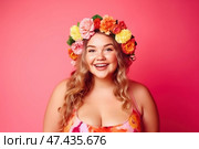 Happy woman in wreath of flowers on pink background, chubby plus size model portrait. Стоковое AI-изображение, AI-художник Станислав Тарко / Фотобанк Лори