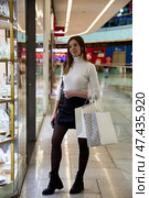 Adult Woman Enjoys Shopping in a Vibrant Mall While Exploring Stylish Window Displays. Стоковое фото, фотограф Aleksandr Golubev / Фотобанк Лори