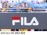 Signboard Fila logo at the sport store. Sport and casual footwear concept. Редакционное фото, фотограф FotograFF / Фотобанк Лори