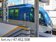 Osaka, Japan - Sep 26 2024, view of the driver's cabin of an intercity electric train standing on the railway platform, with living buildings on background, without people, at daytime, Osaka, Japan. Редакционное фото, фотограф Сергей Богомяко / Фотобанк Лори