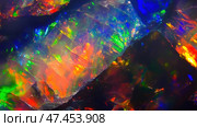 Beautiful opal stone displaying vibrant colors and intricate textures in a natural setting. Стоковое AI-изображение, AI-художник Ксения Лаптева / Фотобанк Лори