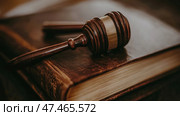 Justice and Law: Gavel Resting Upon an Ancient Tome Representing Legal Precedent. Стоковое AI-изображение, AI-художник Данила Большаков / Фотобанк Лори