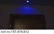 Dim blue light creating haunting atmosphere in empty hotel hallway, shadowy passage near room 220 with barely visible welcome sign. Стоковое видео, видеограф Данил Руденко / Фотобанк Лори
