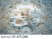 A fantasy winter scene, made in the style of a complex decorative engraving or painting. In the center is a snow-covered city with architecture reminiscent of ancient Rus': domes, towers, monasteries. An old carriage moves along the snow-covered landscape. The entire image is framed by ornate ornaments with elements of flora, curls, decorative frames, snowflakes and birds. The illustration is permeated with a fairy-tale spirit and the atmosphere of a winter fairy tale, like an engraving on porcelain or the pages of an old book. Стоковое AI-изображение, AI-художник Анна Кривицкая / Фотобанк Лори