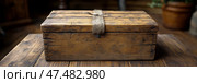 Timeworn Treasure: Antique wooden box secured with twine, evoking rustic charm and containing secrets from bygone era. Стоковое AI-изображение, AI-художник Данила Большаков / Фотобанк Лори