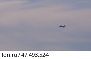 Passenger jet rising through cloudy skies, climbing steeply after takeoff with turbine engines generating strong forward thrust. Стоковое видео, видеограф Данил Руденко / Фотобанк Лори