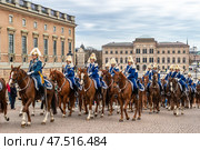 STOCKHOLM, SWEDEN - APRIL 30, 2018: Royal Guard cavalry on horses in blue uniforms. The celebration of King Carl XVI Gustaf 72 years old, at the Royal Palace in Stockholm. Редакционное фото, фотограф Сергей Комаров / Фотобанк Лори