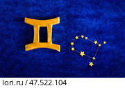 Top view golden zodiac sign Gemini on blue velvet background. Стоковое фото, фотограф Алена Аксенова / Фотобанк Лори