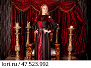 Elegant Noblewoman Posed Proudly in a Majestic Indoor Setting With Opulent Decor and Rich Colors. Стоковое фото, фотограф Aleksandr Golubev / Фотобанк Лори