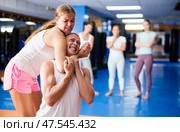 Young woman practicing self defence techniques with coach. Стоковое фото, фотограф Яков Филимонов / Фотобанк Лори