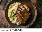 Delicious roast beef draped in rich demi-glace gravy. The savory, tender meat glistens as the sumptuous sauce enhances its juicy flavor, perfect for a gourmet dining experience. Стоковое AI-изображение, AI-художник Nart / Фотобанк Лори
