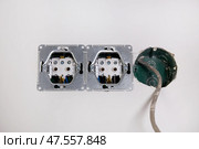 Three electrical boxes for conduits are built into the wall. Work on installing electrical outlets. Стоковое фото, фотограф Виктория Тельминова / Фотобанк Лори