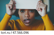Young woman hiding and showing her face with a blank sign. Стоковое AI-видео, аниматор Юрий Поздников / Фотобанк Лори
