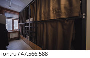 Hostel room with brown curtains providing privacy in capsule beds. Стоковое фото, фотограф Mikhail Davidovich / Фотобанк Лори