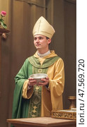 Priest Holding a Bowl of Ashes During Ash Wednesday Ceremony in a Church Setting, Emphasizing the Significance of the Ritual and Community Gathering. Стоковое AI-изображение, AI-художник Sergey Grishin / Фотобанк Лори