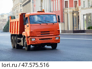 Large truck with orange body drives along a city street. Public utilities service. Стоковое фото, фотограф Ирина Михайличенко / Фотобанк Лори