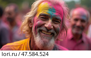 Colorful Celebration of Holi With a Smiling Elder Man Covered in Vibrant Gulal Powder During the Festival of Colors. Стоковое AI-изображение, AI-художник Sergey Grishin / Фотобанк Лори