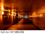Underground pedestrian crossing. A long concrete tunnel with lanterns in the city underground. Underpass. underground passage. Стоковое фото, фотограф Ирина Михайличенко / Фотобанк Лори