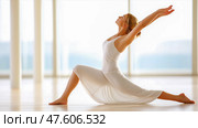 A woman doing yoga, stretching, pacification, calmness. Стоковое AI-изображение, AI-художник Ирина Ручушкина / Фотобанк Лори
