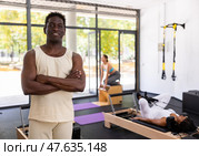 Portrait of man in sportswear posing in pilates studio. Healthy lifestyle and fitness concept. Стоковое фото, фотограф Яков Филимонов / Фотобанк Лори