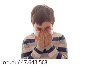 a boy with closed eyes sneezes or coughs in his hands on white background. Стоковое фото, фотограф Zakharova Natasha / Фотобанк Лори