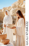 Ritual Ablution: Ancient woman offering water for cleansing ceremony, purity and tradition depiction. Стоковое AI-изображение, AI-художник Данила Большаков / Фотобанк Лори