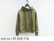 Blank khaki green hoodie sweatshirt long sleeve hanging on simple hook against a white wall. Hoody with hood. Design, print mockup. Template sport clothes. Front view. Gender neutral. Brand, logo. Стоковое AI-изображение, AI-художник Марина Демидюк / Фотобанк Лори