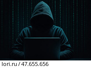 Хакер. Человек в худи за ноутбуком на фоне цифрового кода. Стоковое AI-изображение, AI-художник Башкирова Анна / Фотобанк Лори