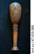 Aged Wood Artifact: Still life of a timeworn mallet on a dark surface, ideal for historical studies or display. Стоковое AI-изображение, AI-художник Данила Большаков / Фотобанк Лори