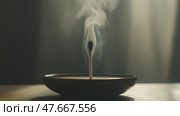 A match burning softly in a dimly lit room with smoke rising. спичка, тихо горящая в тускло освещенной комнате, от которой поднимается дым. Стоковое AI-изображение, AI-художник Katsiaryna Repich / Фотобанк Лори